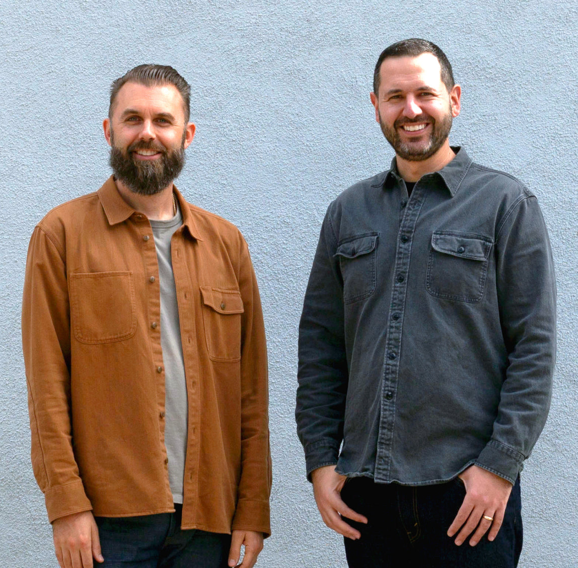 The Tortuga co-founders standing in front of a city skyline